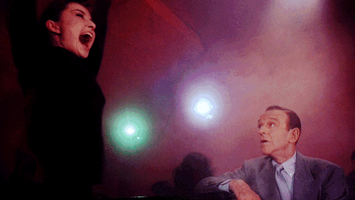 a man and a woman are standing next to each other in a room