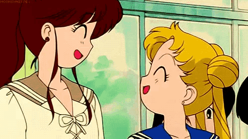 a couple of girls are standing next to each other and talking .