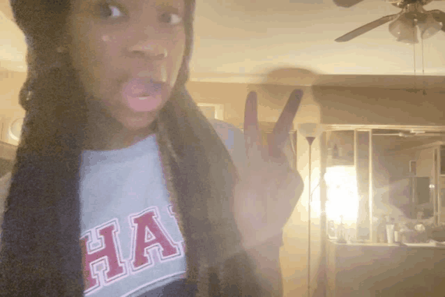 a girl wearing a shirt that says ha on it