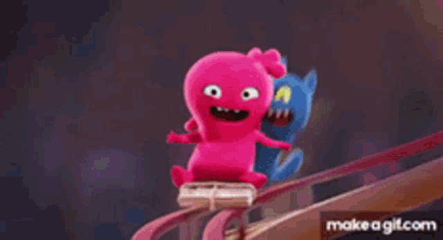 two stuffed animals are sitting on a roller coaster .