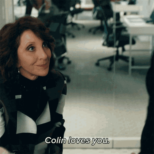 a woman says colin loves you in a room
