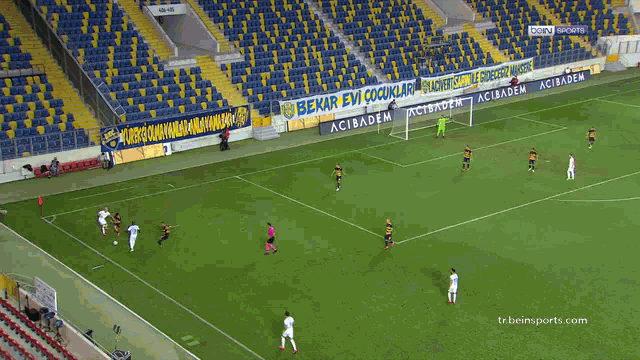a soccer game is being played in front of a banner that says mrs
