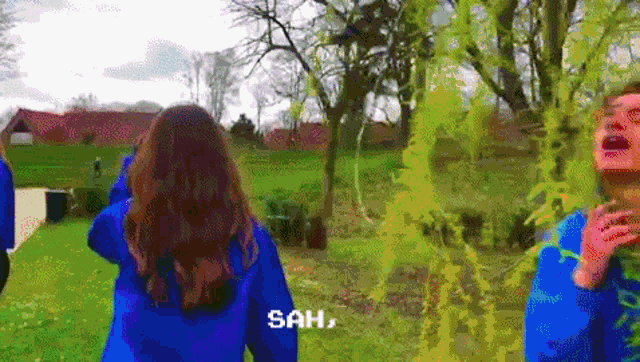 a woman in a blue jacket is standing next to a man in a blue jacket with the words sah written on it