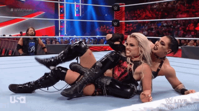 two women are wrestling in a wrestling ring with a usa logo in the corner