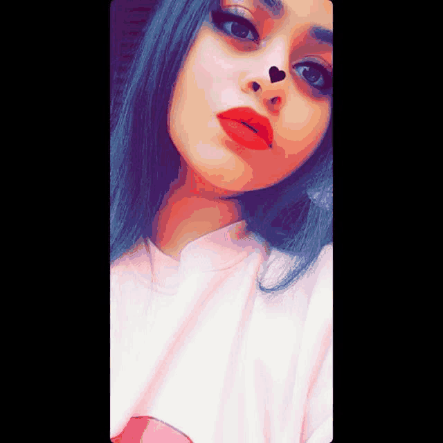 a girl with red lipstick and a heart on her nose .