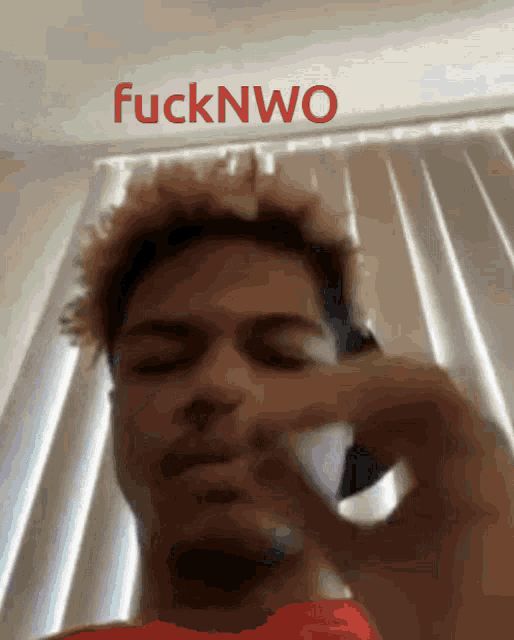 a close up of a man 's face with the word fucknwo above him