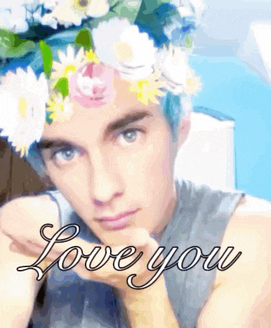 a man with blue hair wearing a flower crown and the words love you behind him