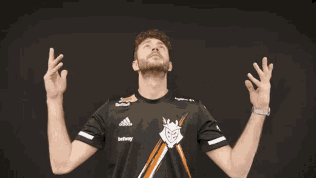 a man wearing a black adidas shirt with red bull on it