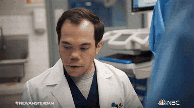 a man in a lab coat with the hashtag #newamsterdam on the bottom