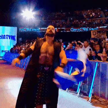 a man in a kilt stands in front of a crowd with a sign that says castle