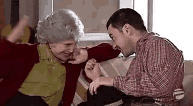 a man and a woman are sitting on a couch .