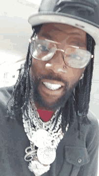 a close up of a person wearing glasses and a bandana that says ' peace ' on it