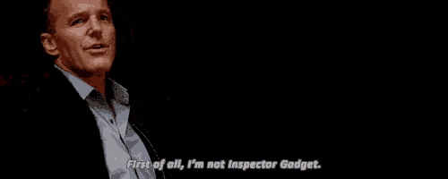 a man is standing in a dark room and saying `` first of all , i 'm not inspector godget '' .