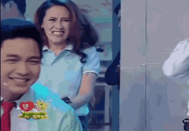 a man and a woman are standing next to each other and smiling