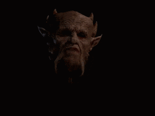 a demon with horns and a beard is looking at the camera