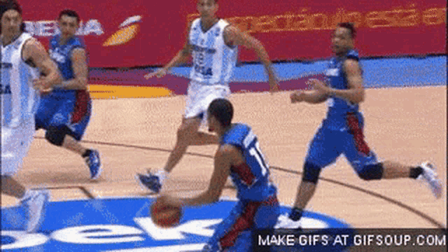 a group of basketball players are playing a game on a court with a beko sign in the background .