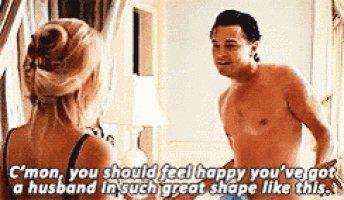 a man without a shirt is standing next to a woman in lingerie .
