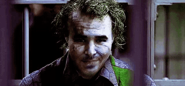 a close up of the face of the joker from the movie the dark knight .