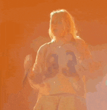 a woman is standing on a stage holding a microphone .