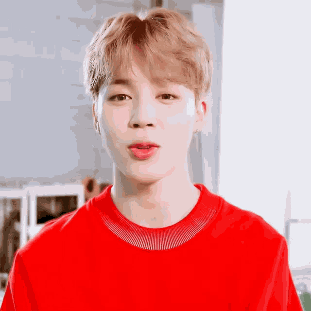 a close up of a person wearing a red sweater