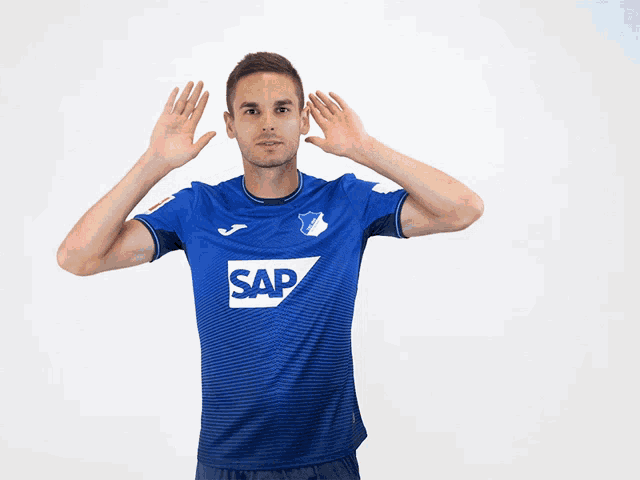 a man wearing a blue shirt with the word sap on the front