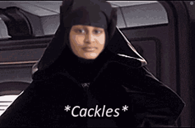 a woman wearing a black hooded jacket and a black hijab