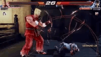 a man in a red suit is playing a video game with the number 26 on the screen .