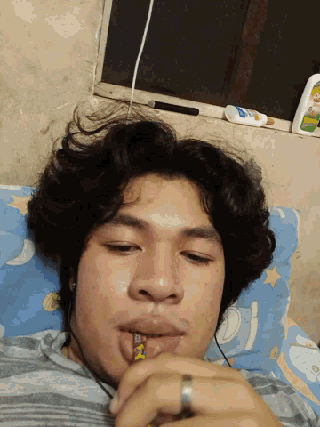 a person with a ring on their finger laying on a bed