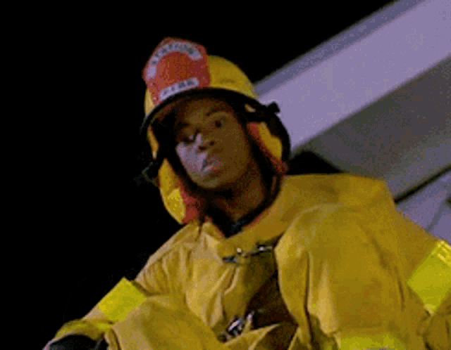 a man wearing a fireman 's helmet with the word fire on it