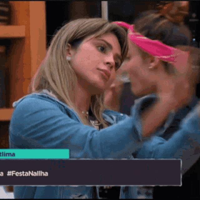 two women are standing next to each other and one has a pink headband on her head