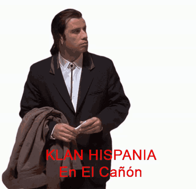 a man in a suit is standing in front of a white background that says klan hispania en el canon
