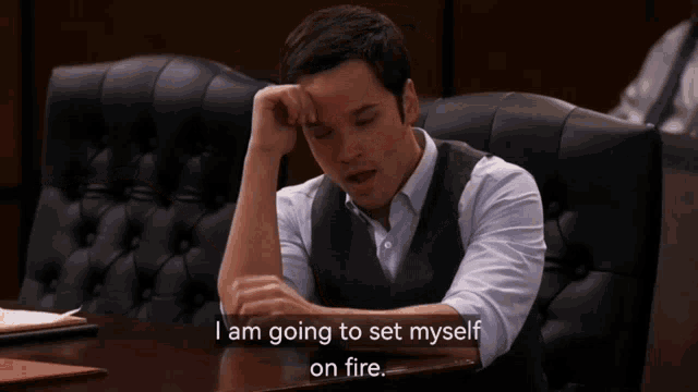 a man sitting at a table with the words i am going to set myself on fire