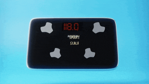 a smart scale displays a weight of 118.0 kilograms