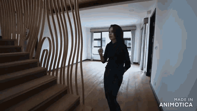 a woman is standing in a room with the words made in animotica on the bottom