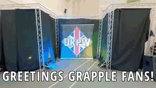 a sign that says greetings grapple fans in front of a sign that says ukpw