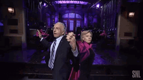 a man and a woman are dancing on a stage with snl written on the bottom of the screen