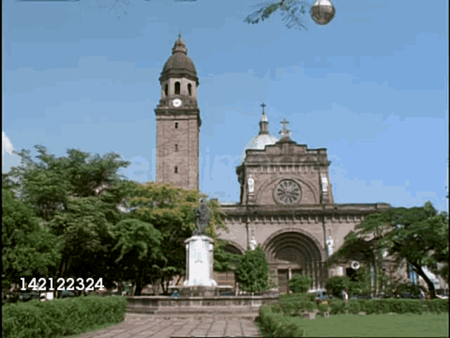 a large building with a clock tower and the number 14212324 on the bottom right
