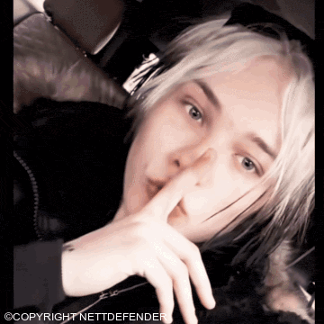 a photo of a woman with her finger on her lips with the words copyright nettdefender below it