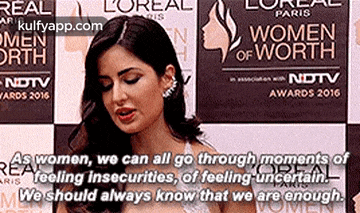a woman is standing in front of a sign that says `` we should always know that we are enough ''