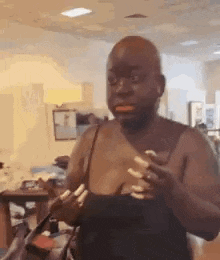 a bald man with long nails is holding a purse in a store .