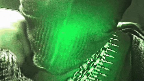 a close up of a person with a green background