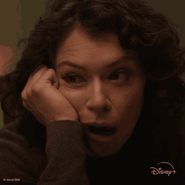 a close up of a woman 's face with a disney logo on the bottom