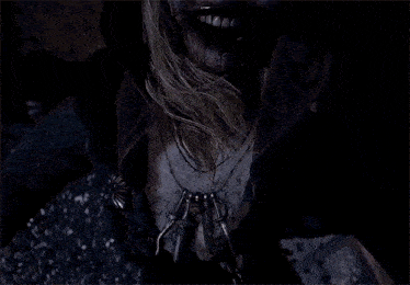 a woman with a beard is surrounded by ants and smiling