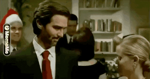 a man in a suit and tie is standing next to a woman