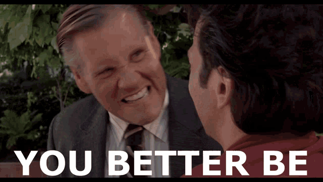 a man in a suit and tie is smiling next to another man with the words you better be below them
