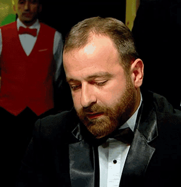 a man with a beard in a tuxedo and bow tie