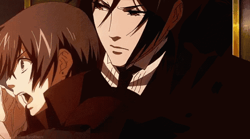 a man in a suit and tie is standing next to a boy in a black coat .