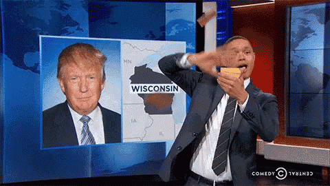 a man in a suit and tie is standing in front of a screen that says wisconsin on it