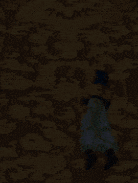 a cartoon character with a pink tail is standing in a desert