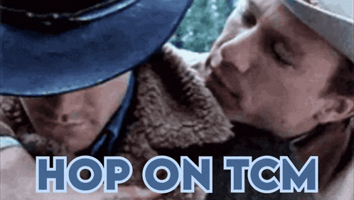 a man in a blue hat is hugging another man with the words hop on tcm above them